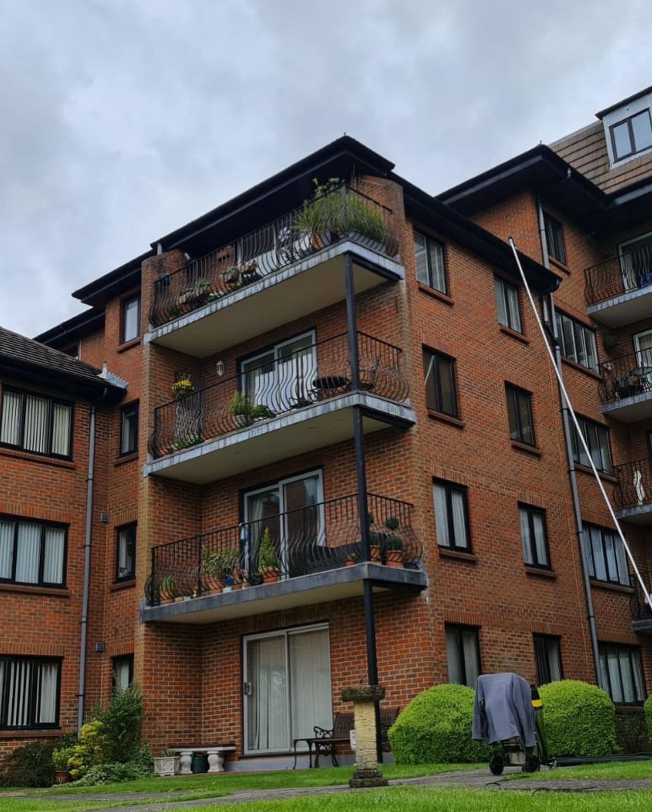 Block of flats having gutters cleaned with vacuum pole Block of flats having gutters cleaned with vacuum pole