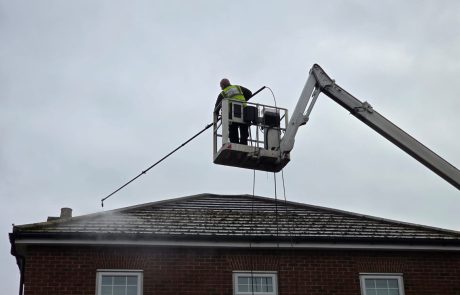Mossy roof being pressure washed Mossy roof being pressure washed