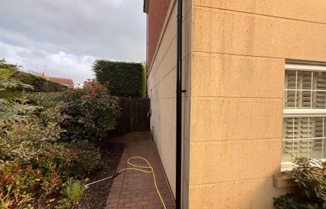 Cleaning debris off a wall after roof cleaning Cleaning debris off a wall after roof cleaning