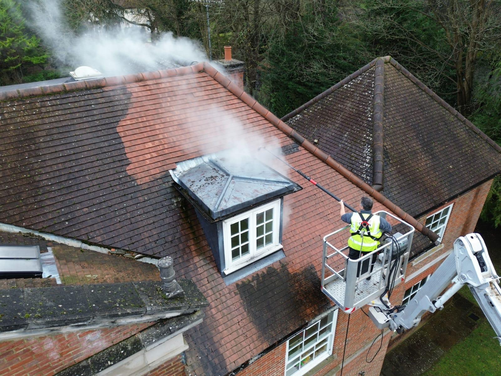 Roof cleaning by Simple Clean employee